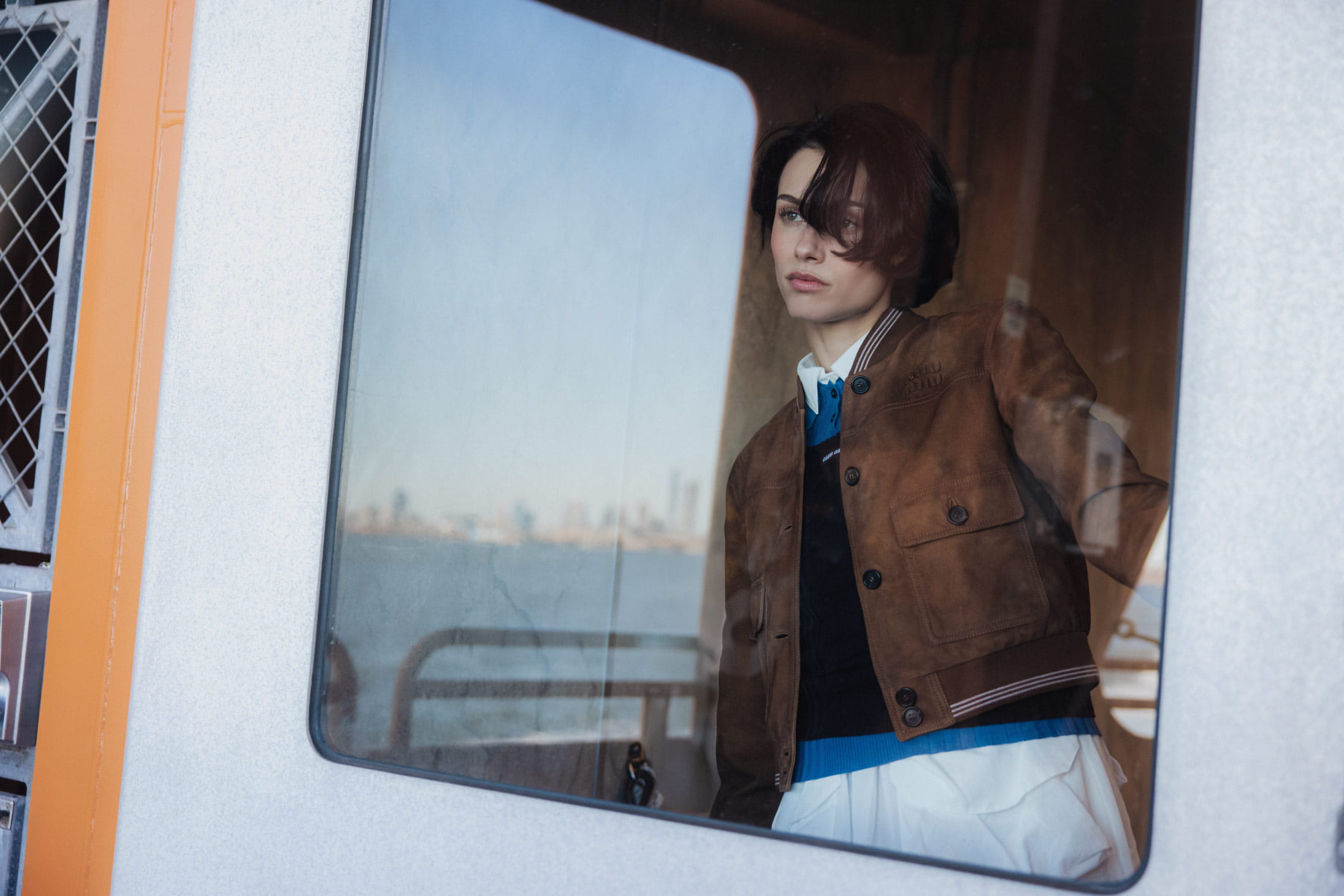 A model poses on the Staten Island Ferry in Miu Miu