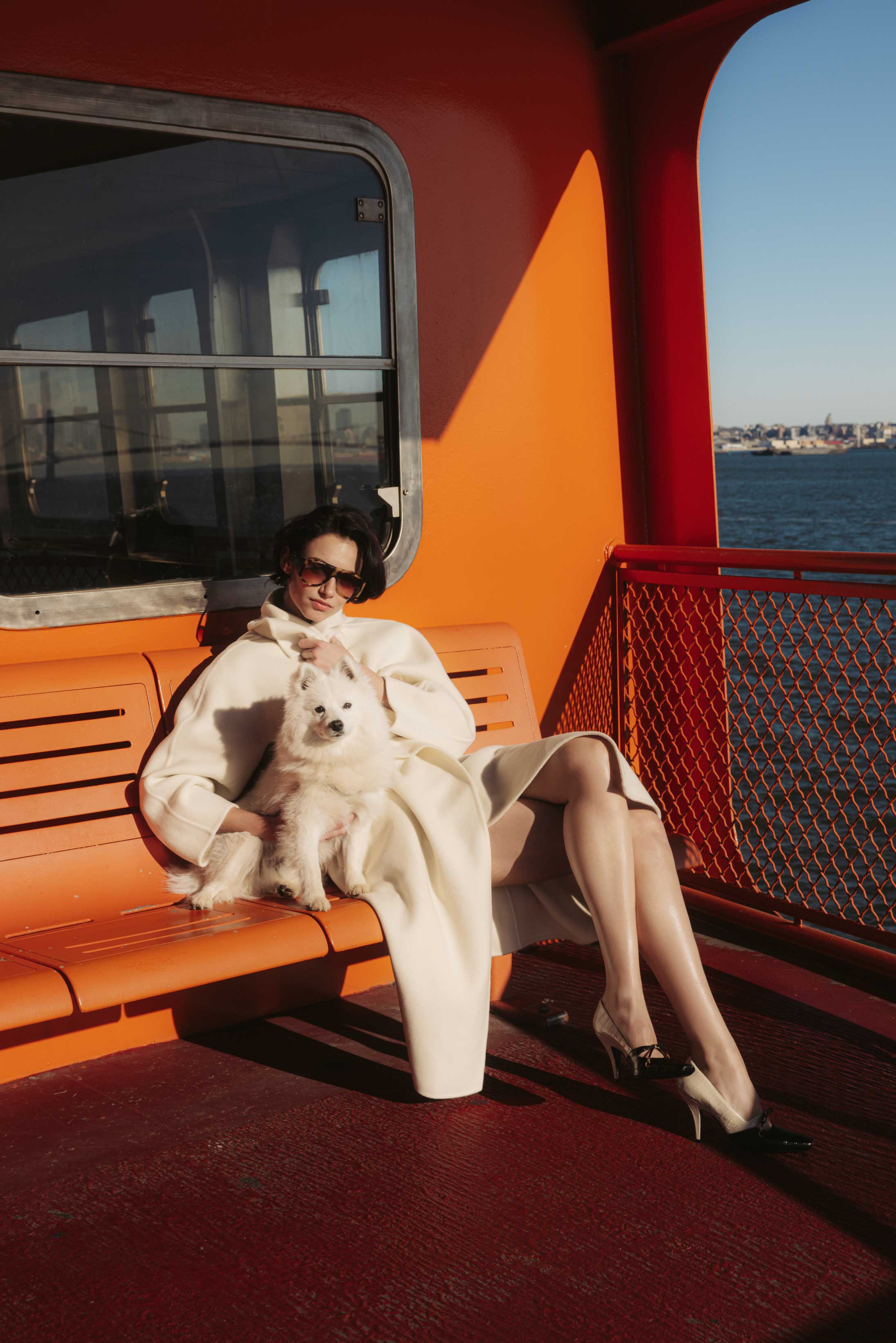 A model poses on the Staten Island Ferry in Max Mara, Dior and Chloé 
