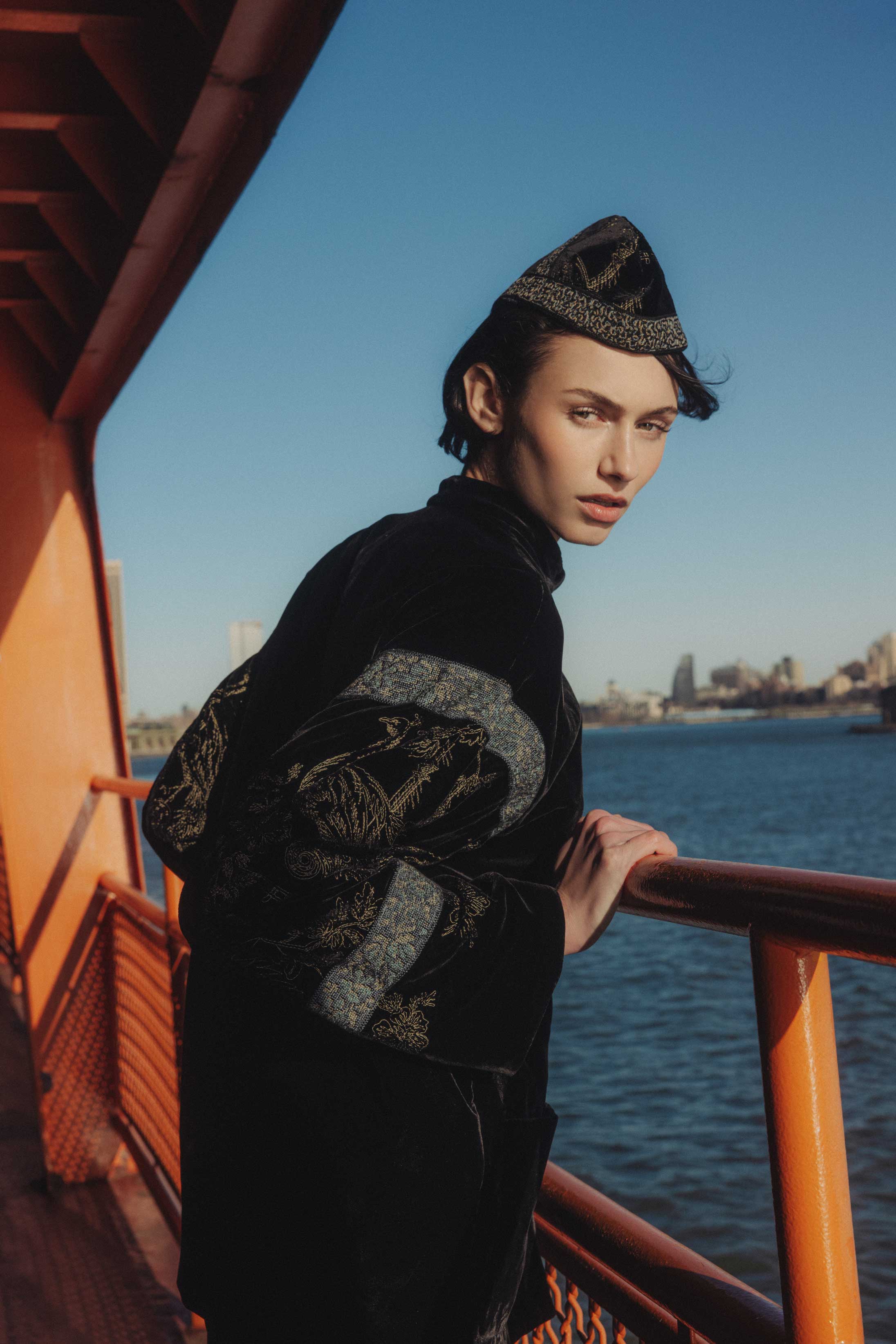 A model poses on the Staten Island Ferry in Emporio Armani