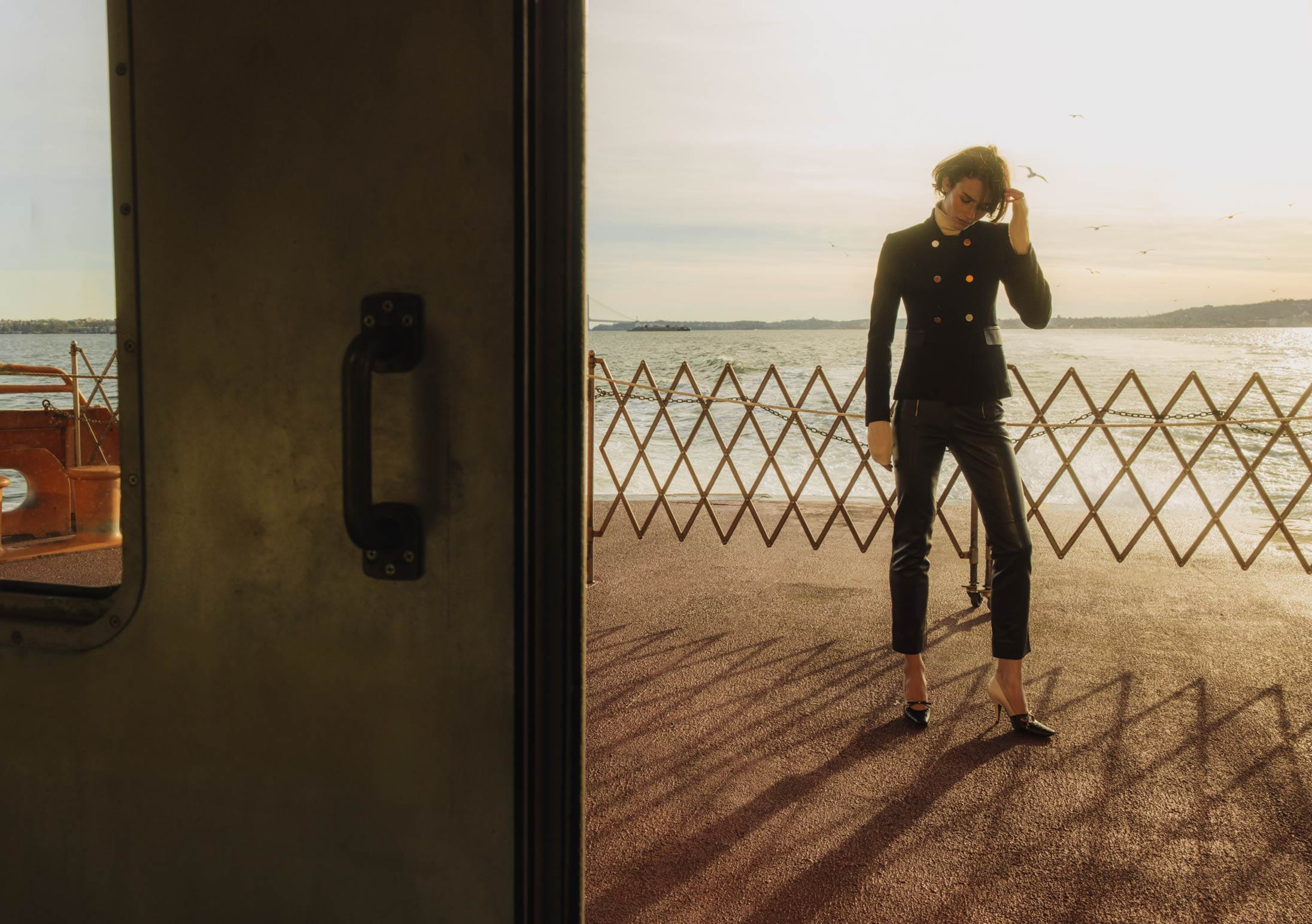 A model poses on the Staten Island Ferry in Hermès and Dior