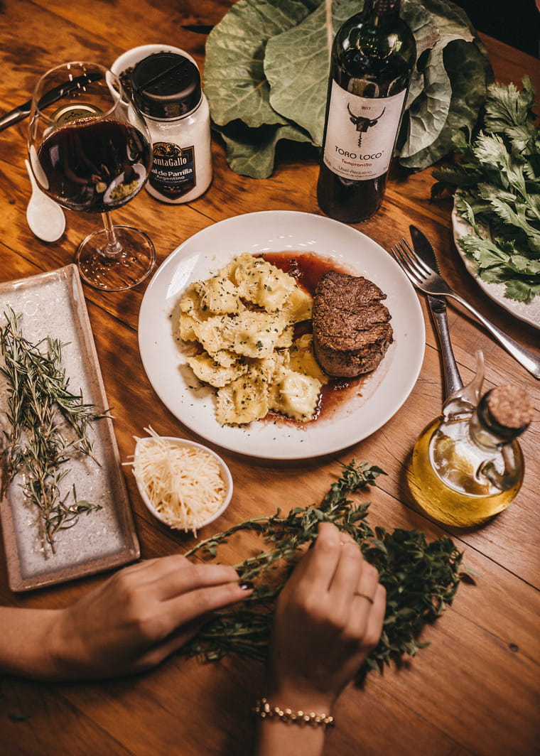 A dish of pasta, steak and herb