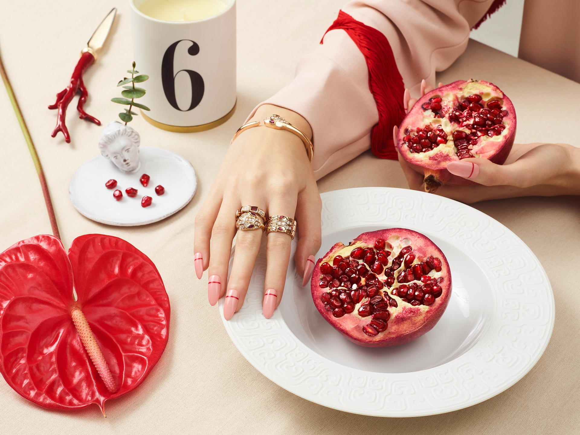 A selection of fine jewellery from Bulgari is paired with sleek stripe nail art