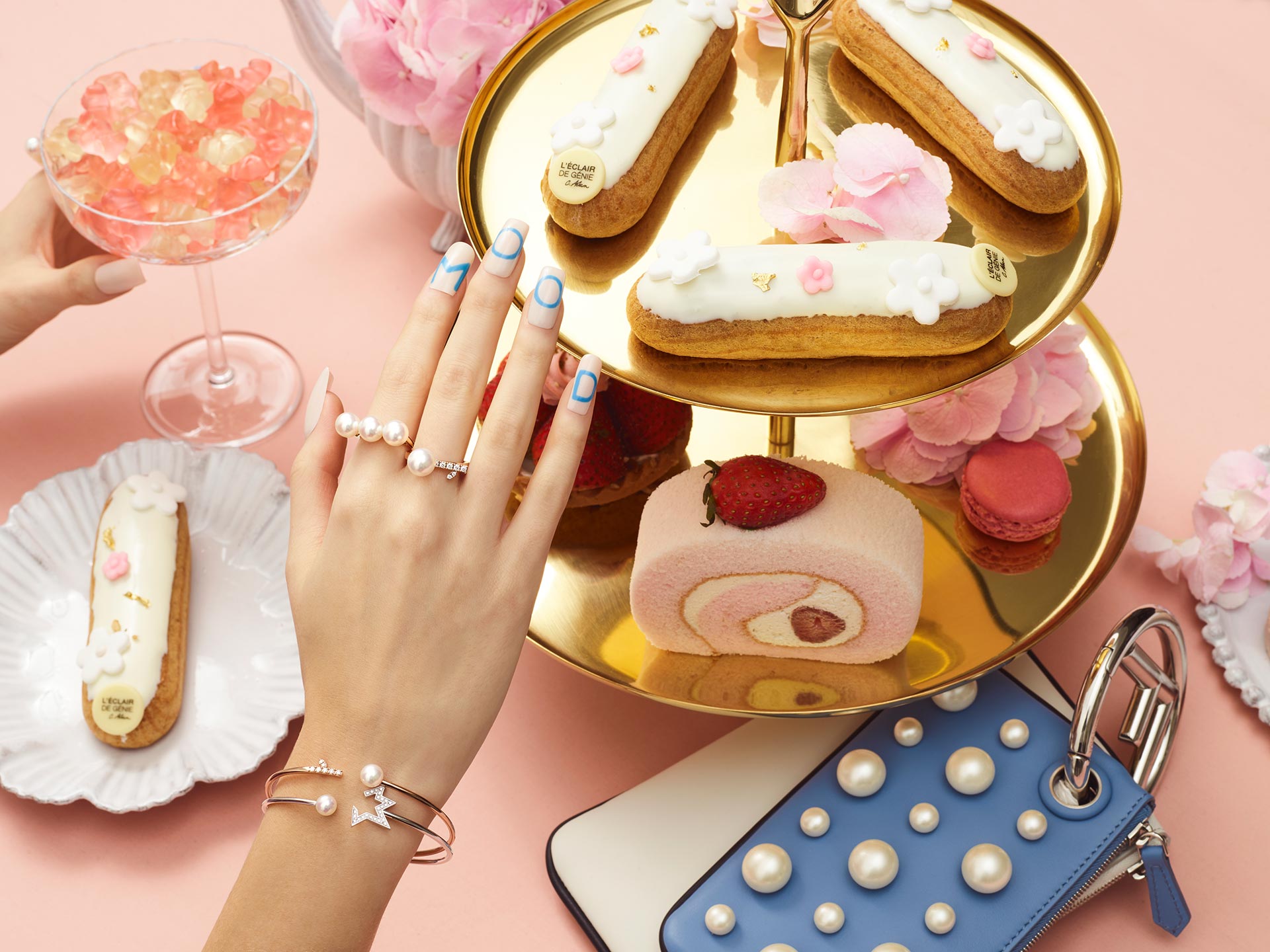 A selection of fine jewellery from TASAKI is paired with paired with ‘mood’ nail art lettering