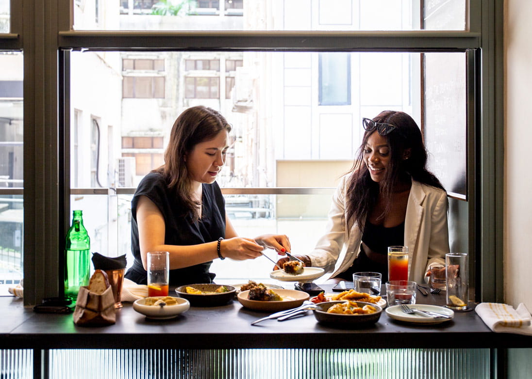 Writer Tegan Smyth and Harmony HK founder Anne-Marie ‘Harmony’ Ilunga tuck into a Sunday lunch at Francis in Starstreet Precinct
