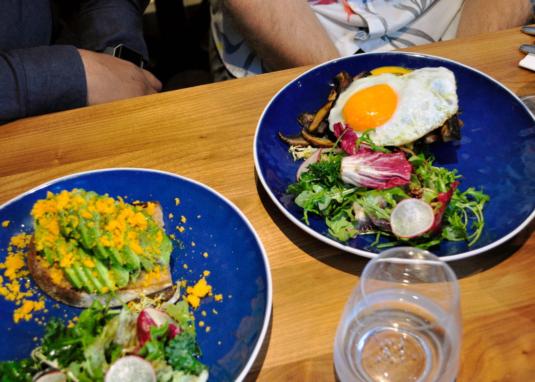 Avocado Tartine with Salted Egg Yolk Crumble (left) and Portobello Mushroom Cheese Fondue Tartine with Sunny-side Egg (right)