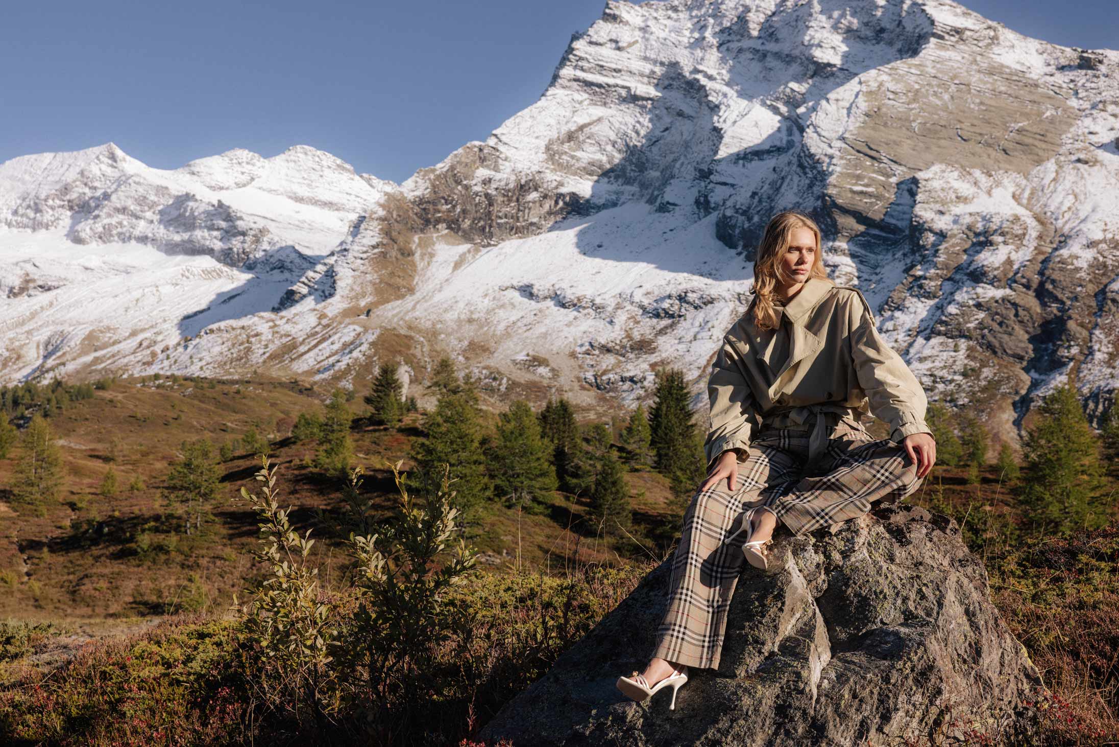 A model poses in the Swiss Alps wearing Burberry and Jimmy Choo