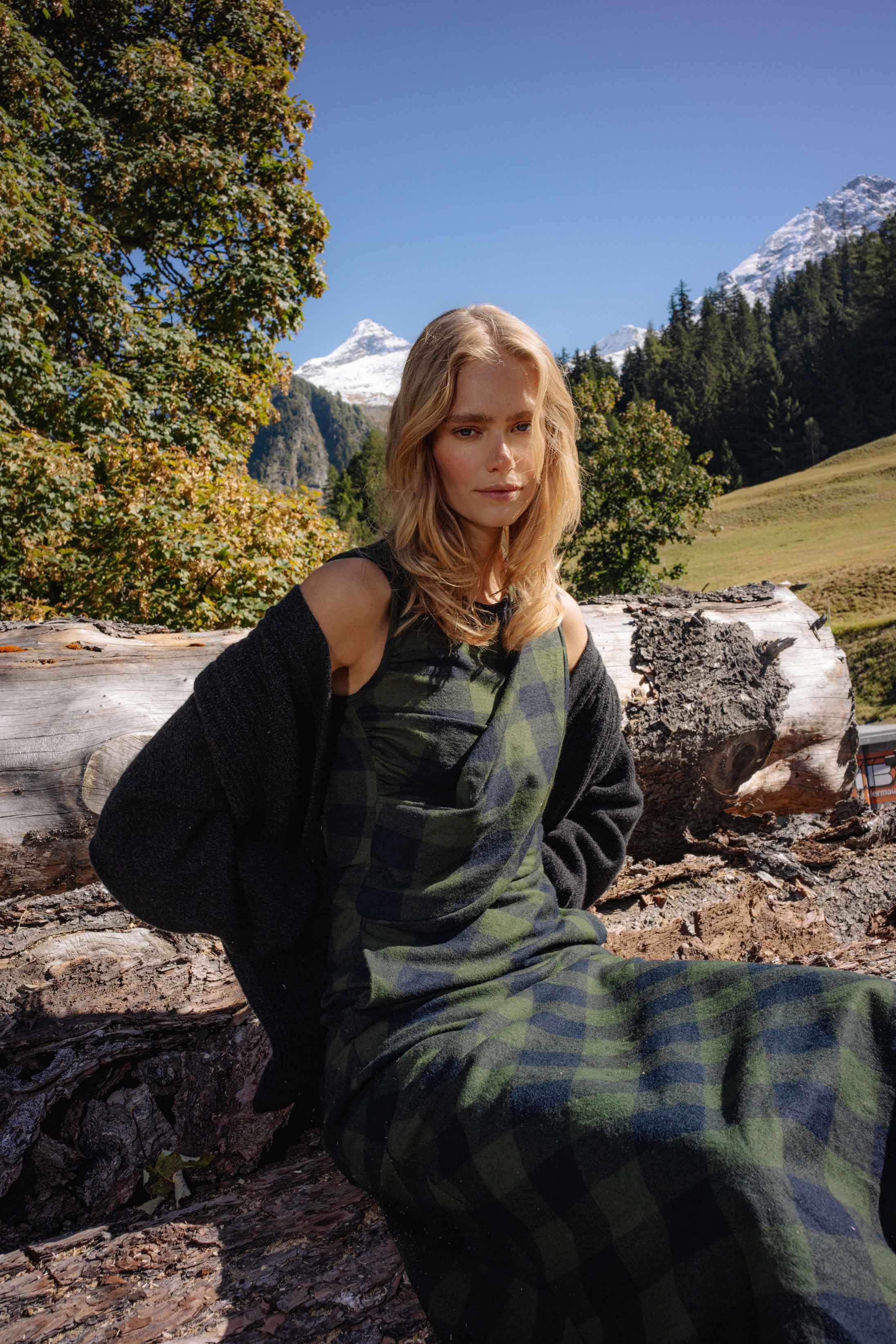 A model poses in the Swiss Alps wearing Longchamp and Hermès