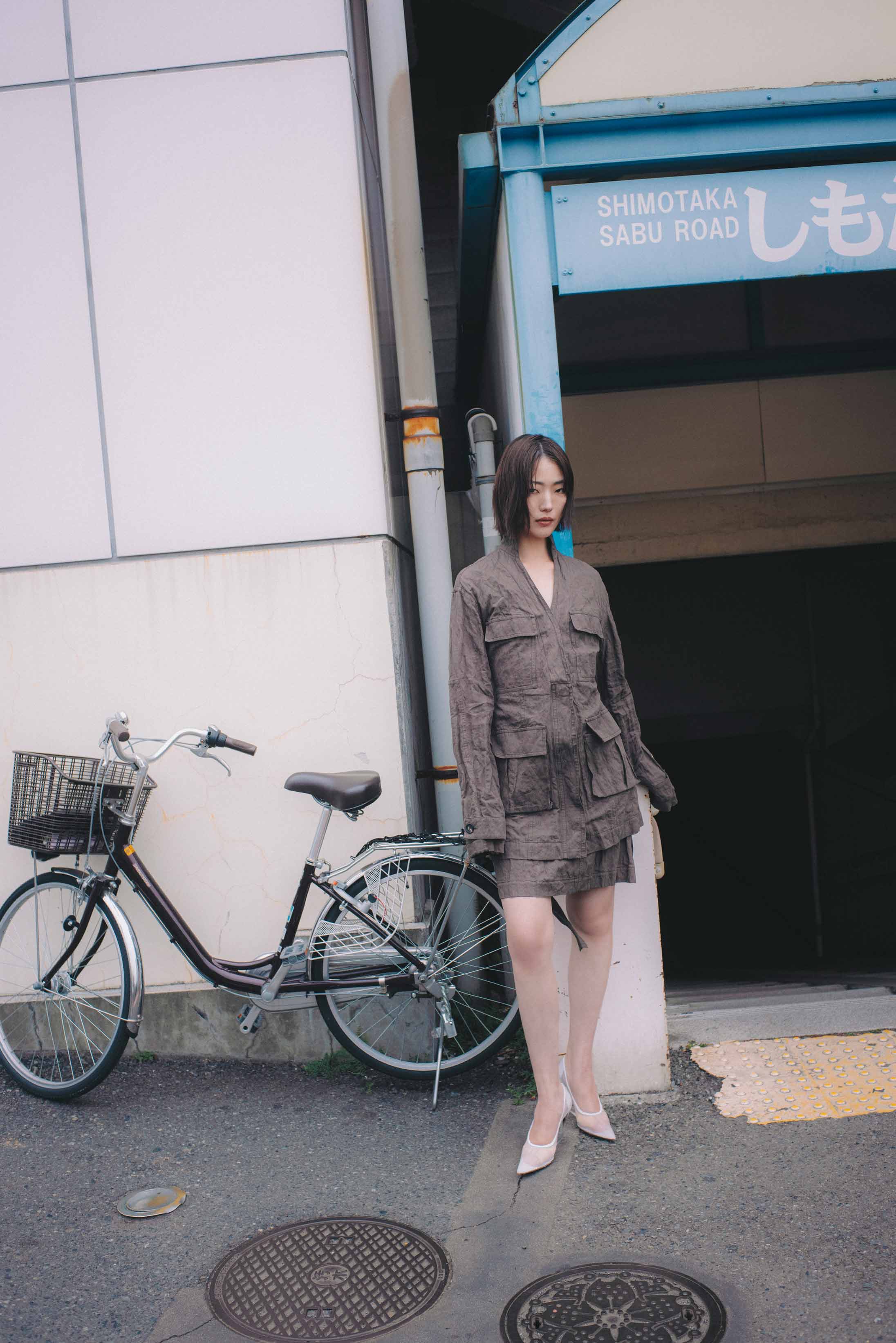 A model poses in Tokyo wearing Ferragamo and Sportmax