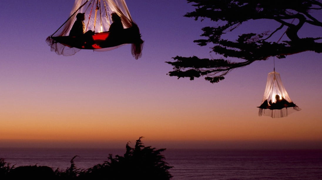 Travellers sleeping in dangling tents