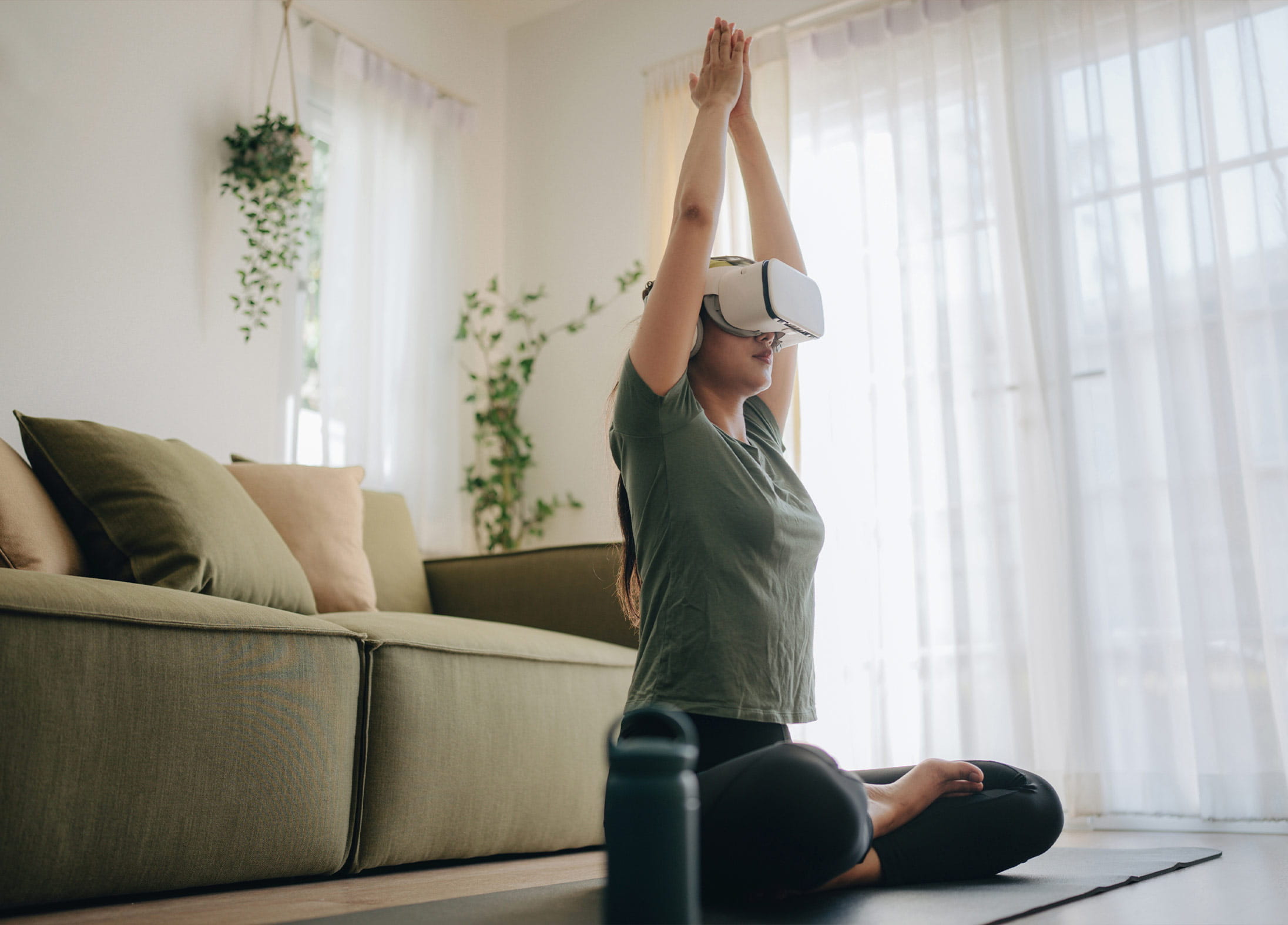 A woman using a VR headset to meditate